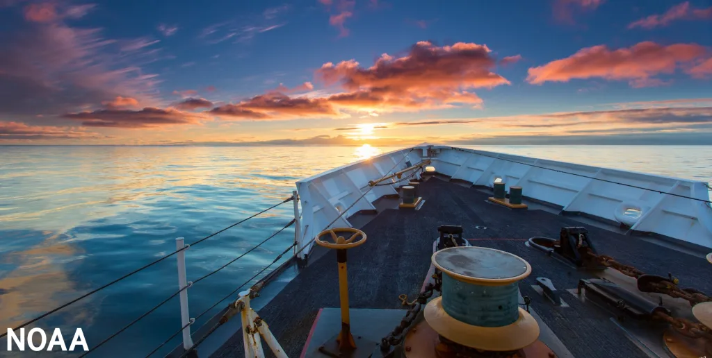 The Coast Guard Cutter Munro from Kodiak, Alaska, sails toward the sunset during an unusually calm evening on the Bering Sea. Credit: USCG