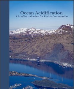 The cover of "An introduction to ocean acidification for Kodiak Communities," a brochure for Kodiak community members to learn more about the topic and community sampling. Mountains with water inlet below and some community roads, structures and harbor in Kodiak, Alaska.