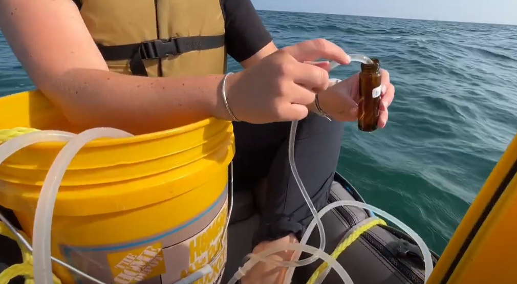 NOAA researcher Maddy Saddler collects water samples from Lake Huron to assess water chemistry and the carbon system as part of a 5 year project. Credit: TBNMS, September 2024